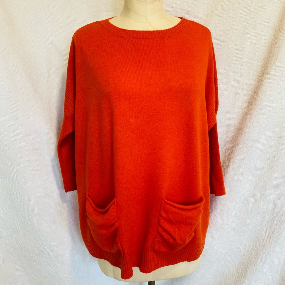 Cashmere/Wool orange relaxed fit sweater with front pockets.